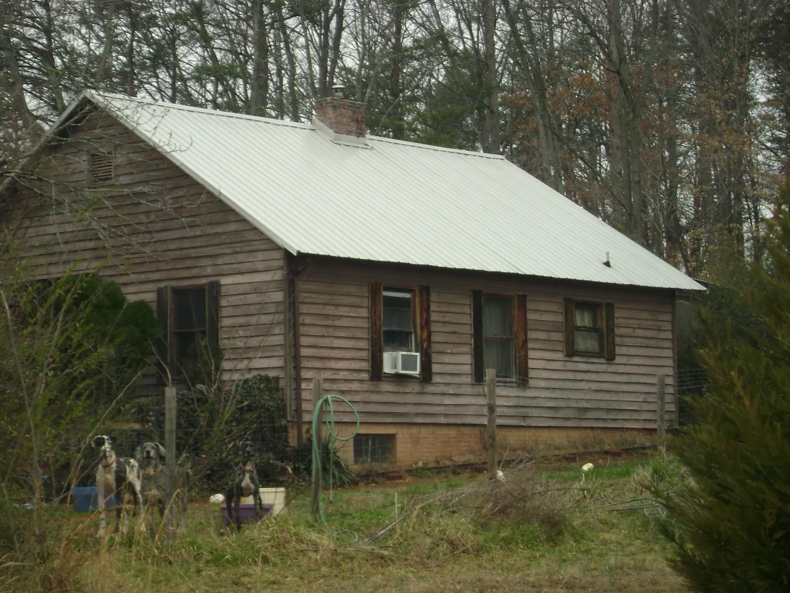 White metal roof on an old wood sided farmhouse, from a Metal Roof Installation job in Bloomfield
